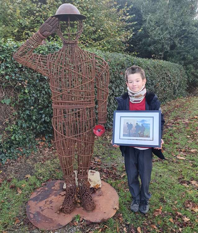 Ollie Bennett with his paining next to the statue outside Holbrook church