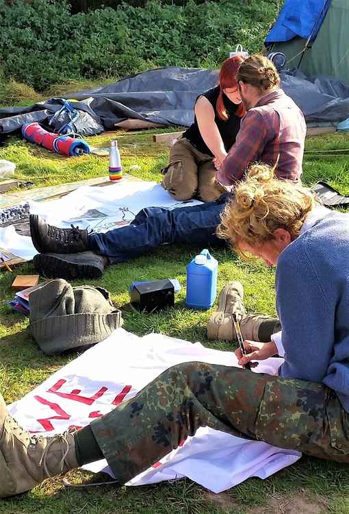 Attendees of the 'Skill Up' event at Crackley Woods camp making banners