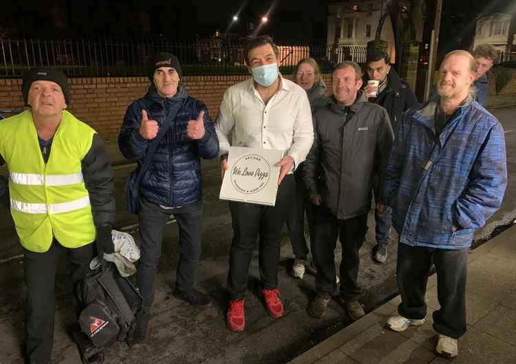 Jose Ribeiro is welcomed by some of the soup kitchen visitors