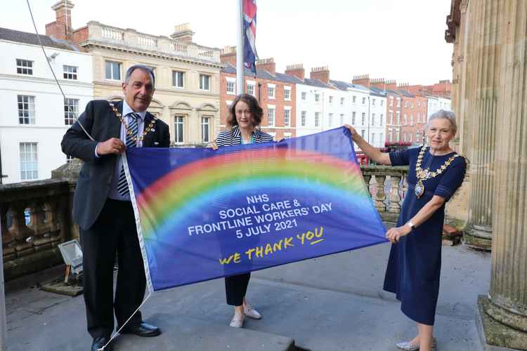 Cllr Neale Murphy, Anne Coyle and Cllr Susan Rasmussen raising the flag at Leamington Town Hall