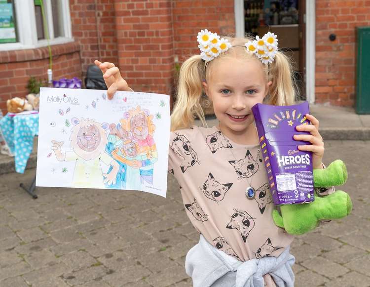 Rosie, 9, with her Olly The Brave colouring in for Molly Olly's Wishes stall. Photo by Victoria Jane Photography.
