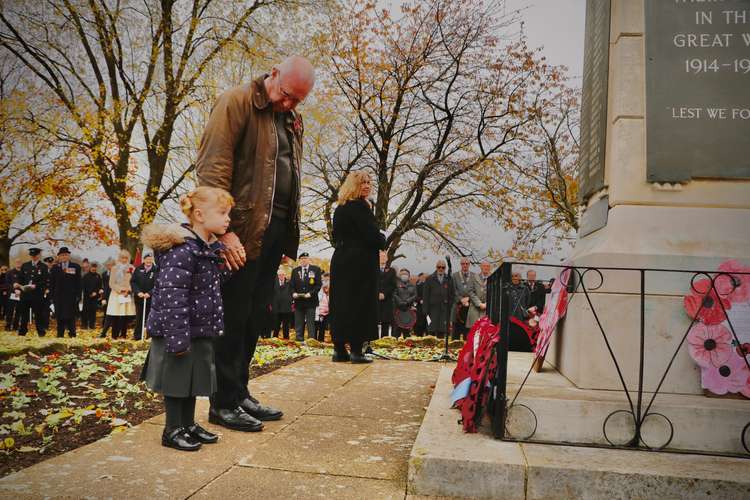 Sophie Cartwright, 4, with her grandad Mark lays a wreath on behalf of the Kenilworth Poppy Appeal