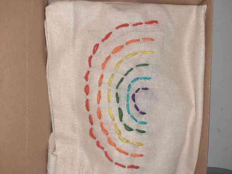 An embroidered bag made by the family