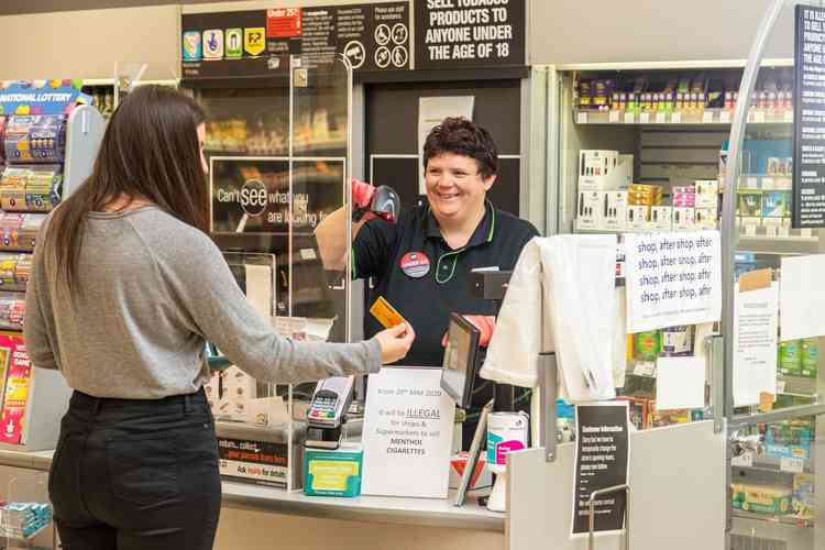 How it should be... A Co-op staff member serving a customer