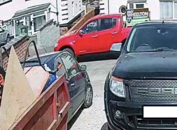 A screenshot from Amy Wheelton's public Facebook page showing her standing beside her red pickup truck, with an election poster board mounted in the back