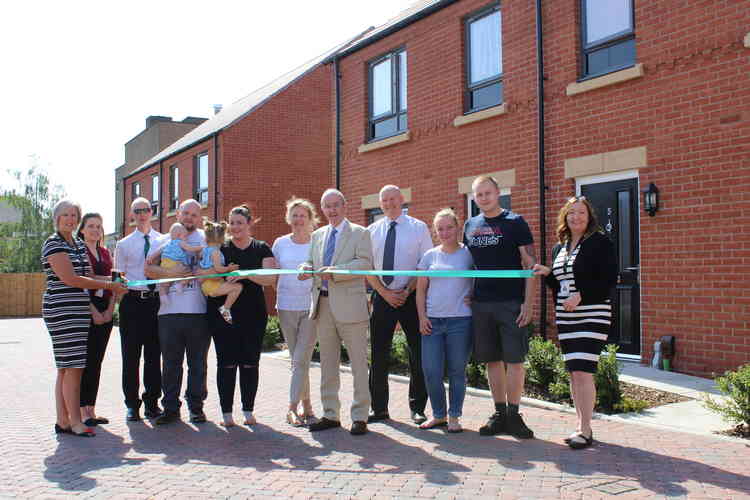 Councillor Roger Bayliss, Portfolio Holder for Housing at North West Leicestershire District Council, was joined by tenants and housing staff to celebrate the opening of new council homes in Ashby Road last year.