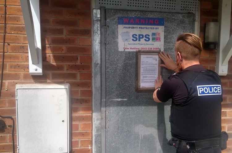 PC Joel Tarplin placing the closure order on the property. Photo: Leicestershire Police