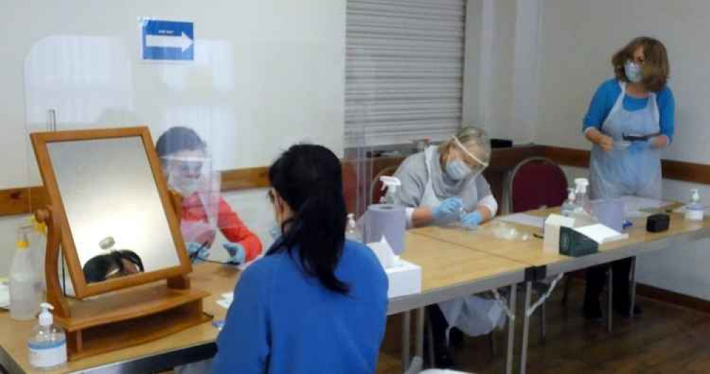 Patsy, Barbara and June process a lateral flow test.