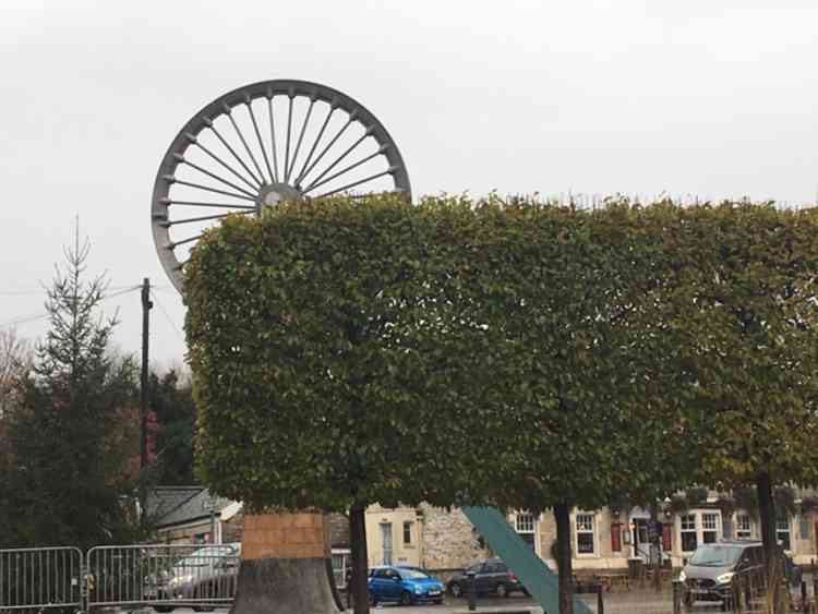 The old coal mining sheave wheel, now featured in the centre of Radstock, in front of the Radstock Museum.