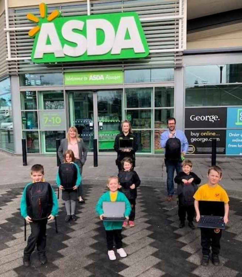 Steve Rowley (Manager of Asda Alsager), Jess Rigby (Asda employee), Debbie Frost (School  Business Manager at Alsager Highfields) and some of the children in Early Years and Key Stage 1 who will  benefit from being able to use these devices in school.