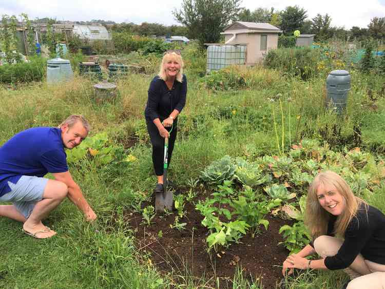 easedown Community Trust Chairman, Gavin Heathcote, along with local councillors Karen Walker and Sarah Bevan, 'get stuck in' at Peasedown Allotments for National Allotment Week.