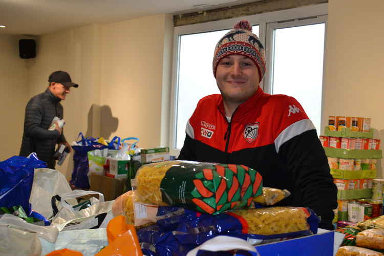 Radstock Town Football Club goalie Jack Scrivens with some of the donations