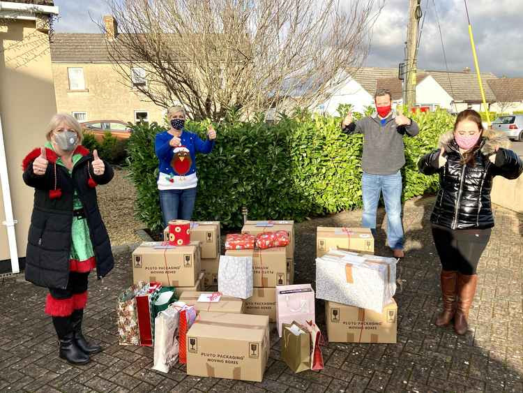 The photo shows some of the Charity's Trustees getting ready to deliver food hampers to families on Christmas Eve, from left to right; Karen Walker, Benice Hampton, Gavin Heathcote and Sam Heathcote.