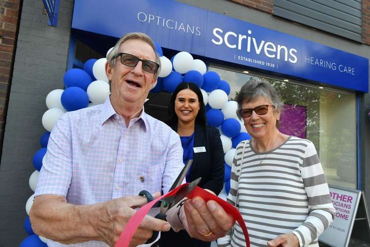 Customers Ken and Lesley Livingston open Scrivens Opticians Alsager new-look branch in July this year as manager Hannah Machin looks on.