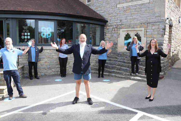 Michael Eavis (centre) celebrates the launch of Pilton's new Co-op with the store team including Vicki McLaurie, Pilton store manager (far right in black)