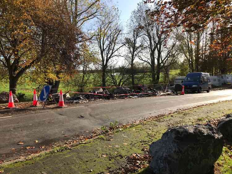 The remains of a roadside caravan that caught fire in Glastonbury