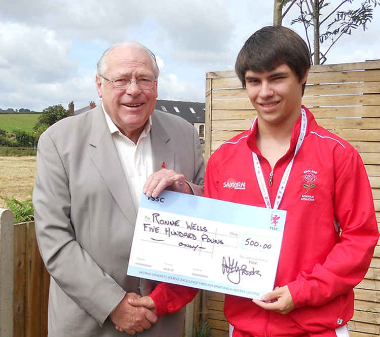 Alan Gloak, TS5C chairman, presenting a grant cheque to one of the charity's young athletes, Ronnie Wells