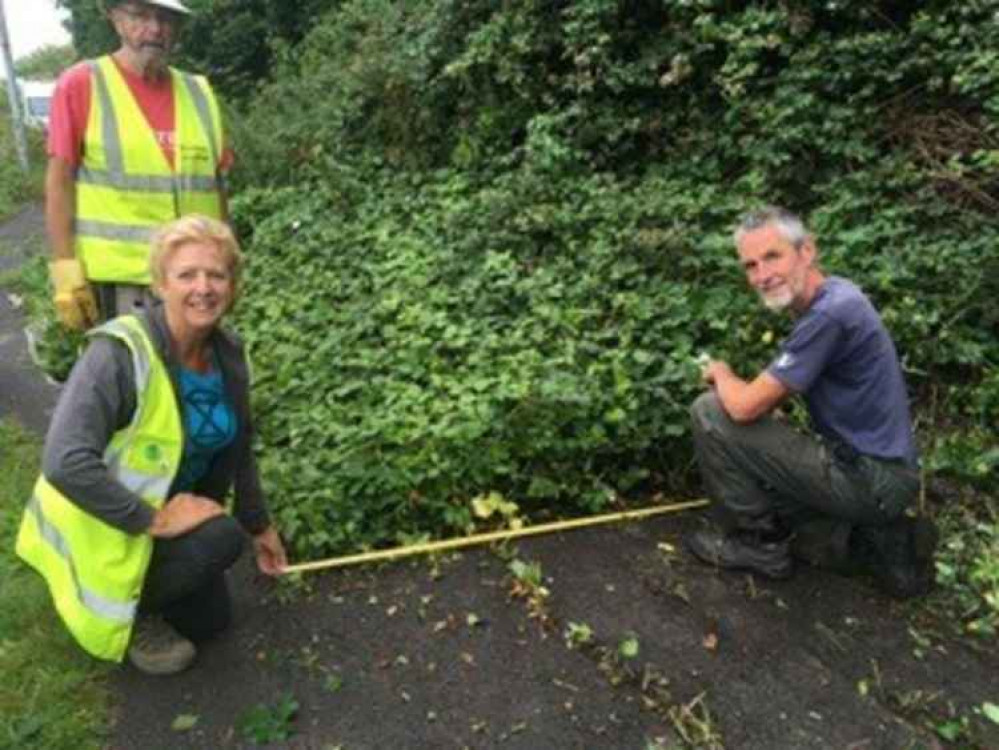 Anthony, Laura and Martin illustrating how only 50cm of path remained before they cleared off all the vegetation