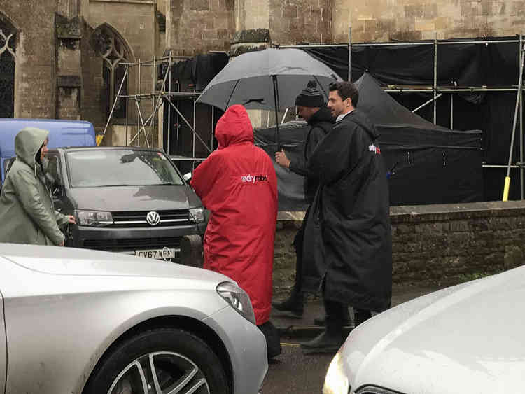 Teresa Palmer (in red rain jacket) with Matthew Goode filming A Discover of Witches in Wells