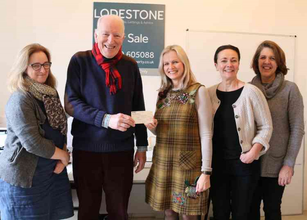 Ross Young from Wells Independents accepts the cheque from Cathy Morris-Adams of Lodestone watched by her colleagues Laura Waters, Liz Fox and Alex Relf