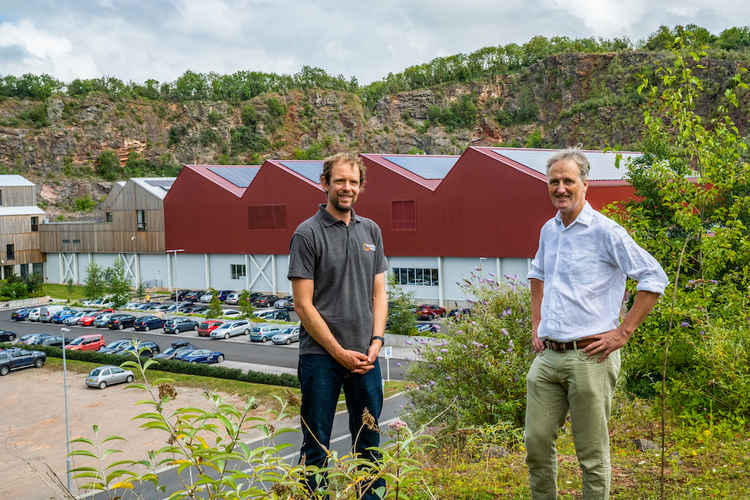 Gabriel Wondrausch (left) and Charlie Bigham in front of the 300 kW solar PV system at Dulcote Quarry