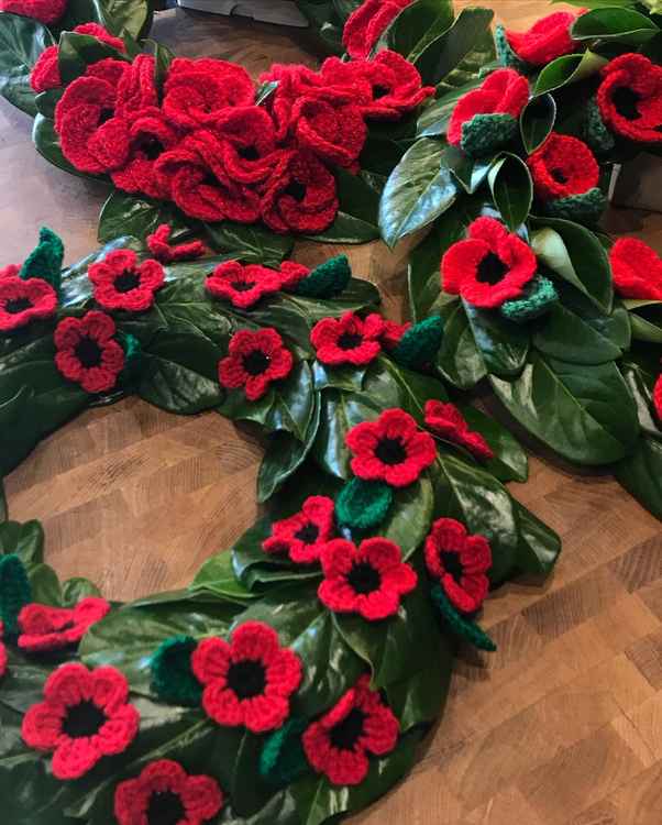 Wreaths of woollen poppies created by Abundiflora, Glastonbury