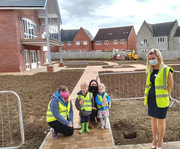 Local children help to bury the time capsule