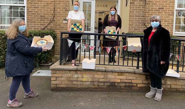 WCN volunteers Trisha Leigh and Judith Blake present the cakes to staff at Fletcher House in Glastonbury Road