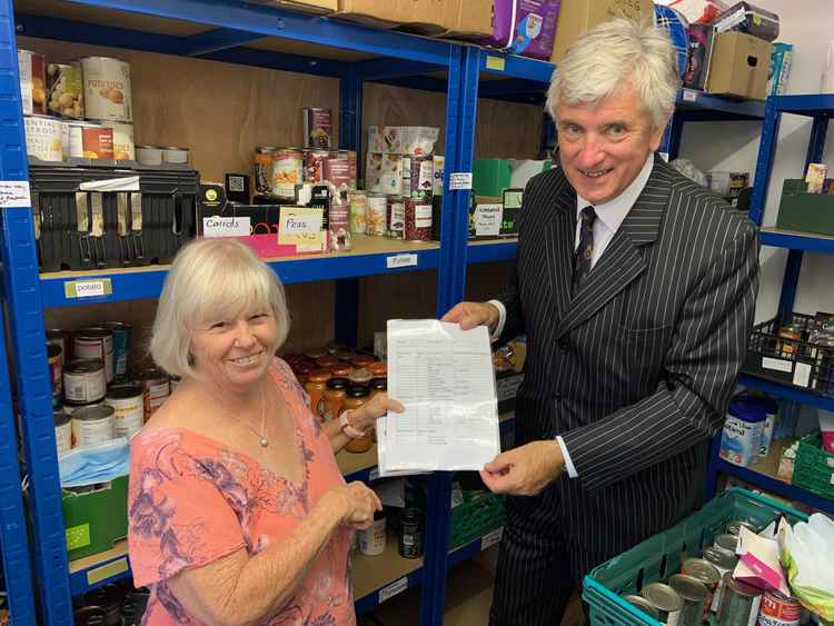 Sue Marland explains to the High Sheriff how they pack food parcels