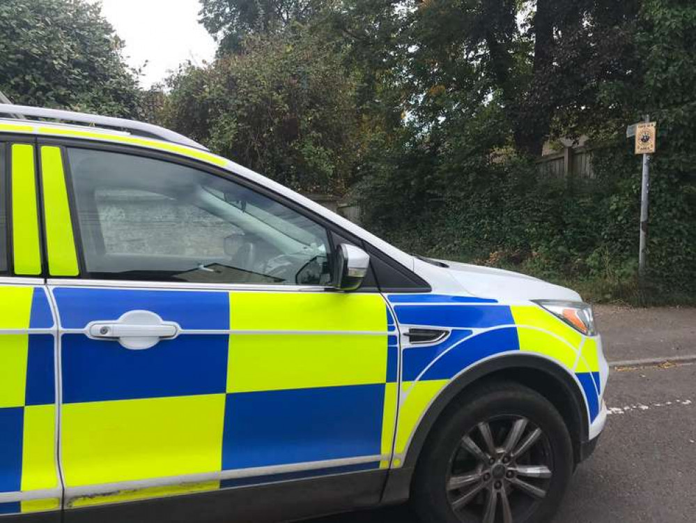 Police at the entrance to the Ash Lane footpath at lunchtime today