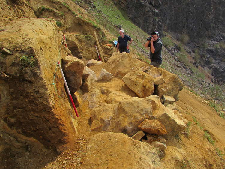 Neil Adam and a field assistant working at the site, taking photographs of the cave sediments (Photo: Neil Adams/University of Leicester)