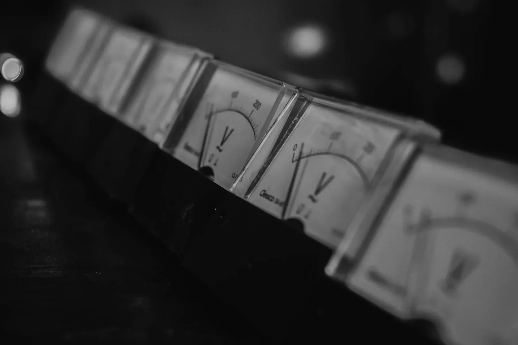Abstract Numr artwork: a row of analogue gauges, two lit.