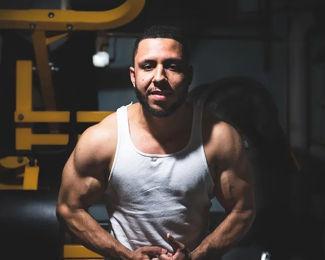 A person flexing their biceps, showcasing muscle growth.