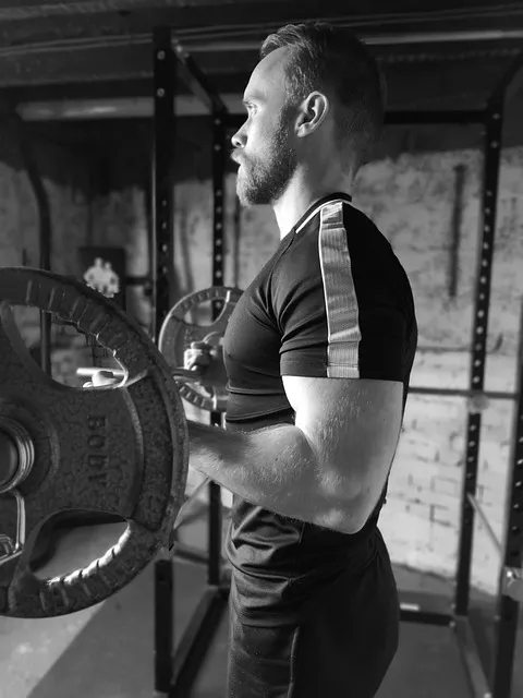 A person performing a bicep curl with proper form, showcasing muscle definition.