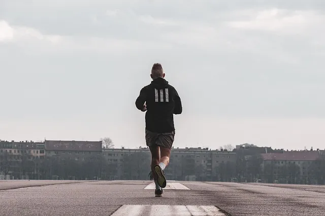 A runner on a track, highlighting muscular endurance.
