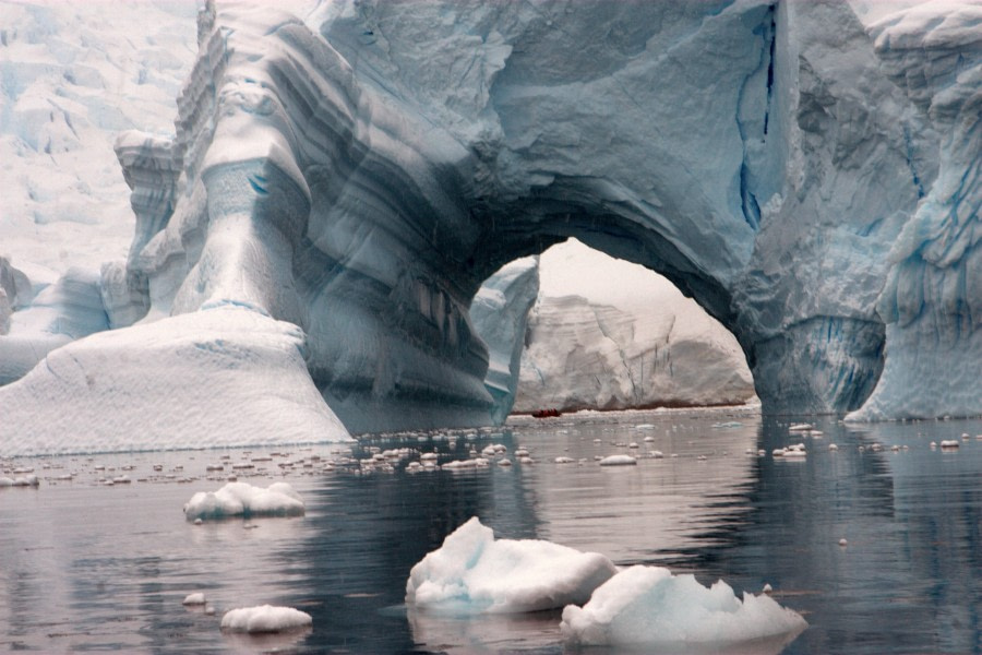 Zodiac cruising among huge icebergs