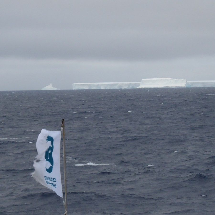 OTL28-17, Ross Sea,Day 20 Victoria Salem. Oceanwide flag & iceberg-Oceanwide Expeditions.JPG