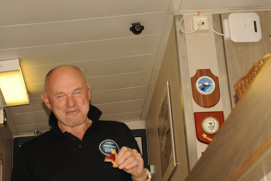 PLA23-18, 8 DEC, Bill sneaking a tart, heading for Ali's talk -Oceanwide Expeditions.jpg