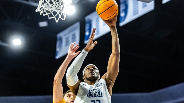 Norfolk,Virginia 20230222- Old Dominion Monarchs forward Dericko Williams (23)scores a bucket inside of the defense of Southern Miss Golden Eagles forward Felipe Haase (22) in tonight's men's Sun Belt basketball matchup between the Southern Miss Golden Eagles @ Old Dominion Monarchs at Chartway Arena in Norfolk,Virginia. The Monarchs upset the Eagles 69-54 raising their record to 18-11, 10-7 in conference. They now host the Thundering Herd of Marshall on Friday night for Senior Night.