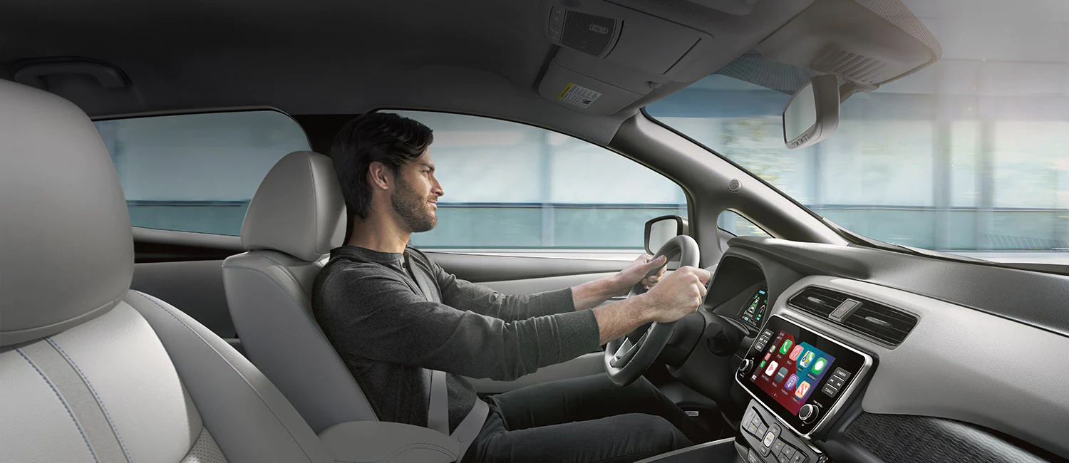 a man driving inside a 2022 LEAF