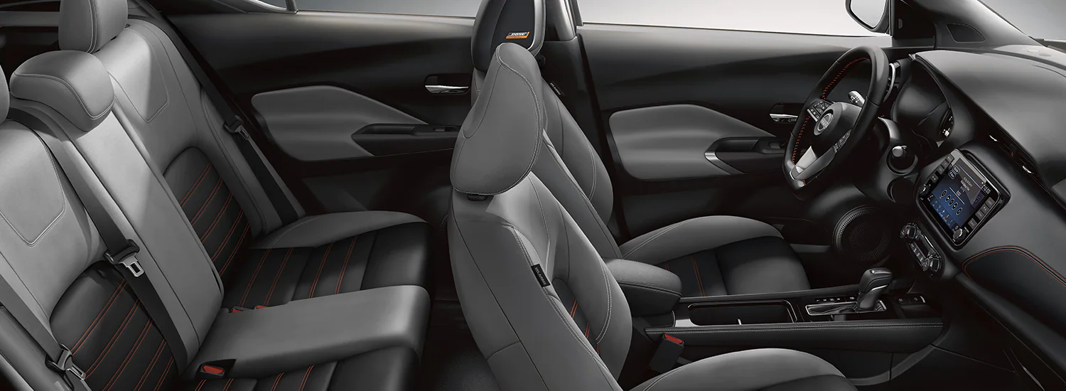 2024 Nissan Rogue with hatch open, a man with a leash and a dog illustrating cargo capacity.