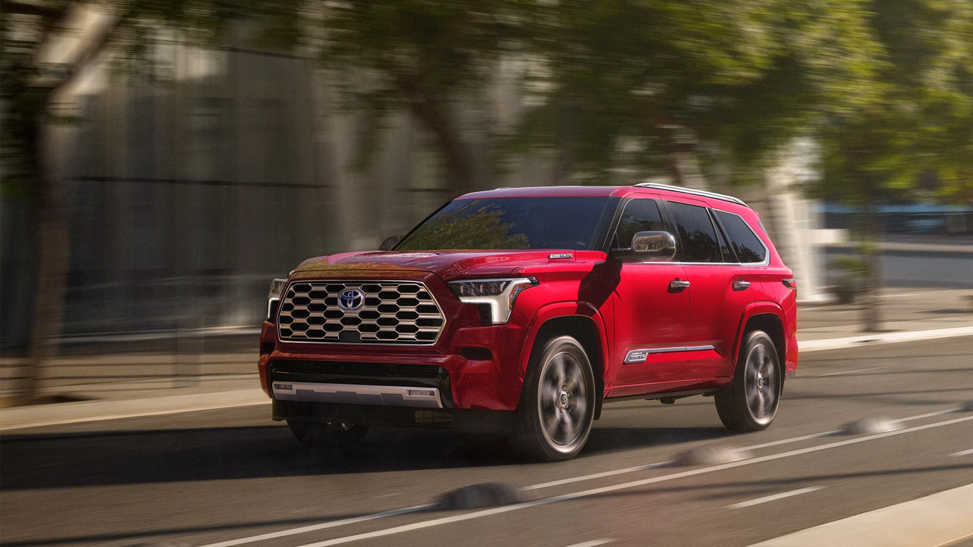 2023 Toyota Sequoia Capstone 4x4 shown in Supersonic Red driving down the road