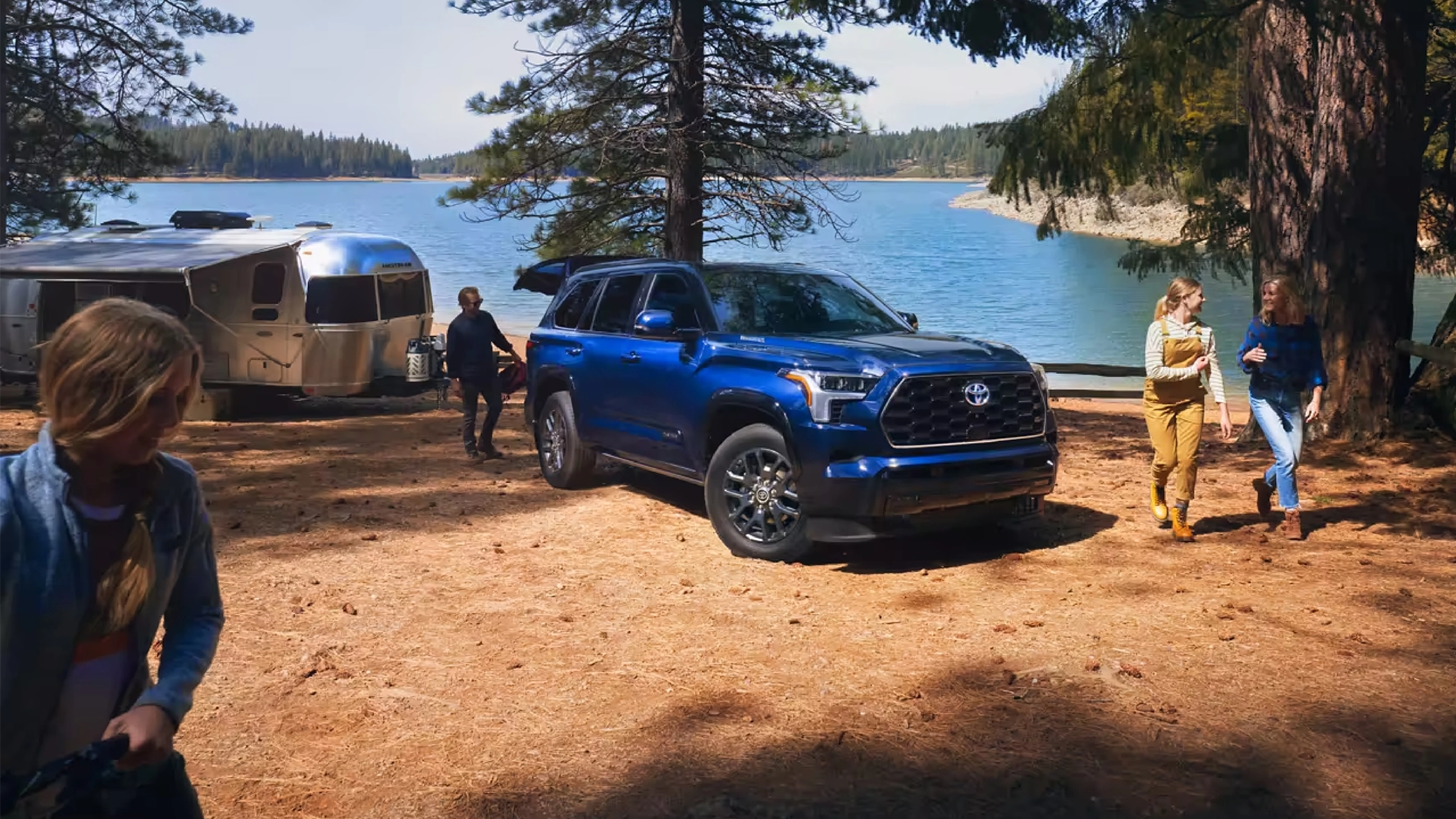 Blueprint 2023 Toyota Sequoia Platinum parked in front of a lake with people walking around