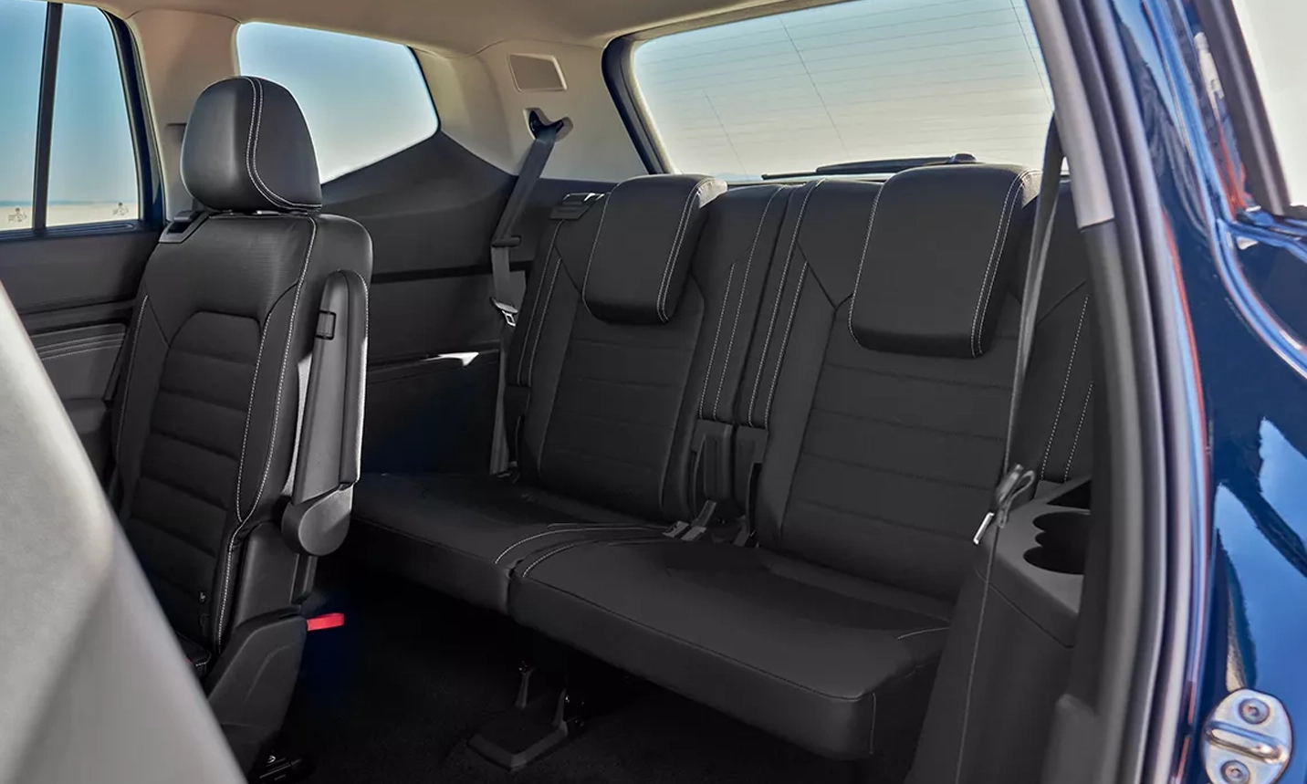 View looking into an Atlas showing the second-row seat folded forward allowing access to the third row.