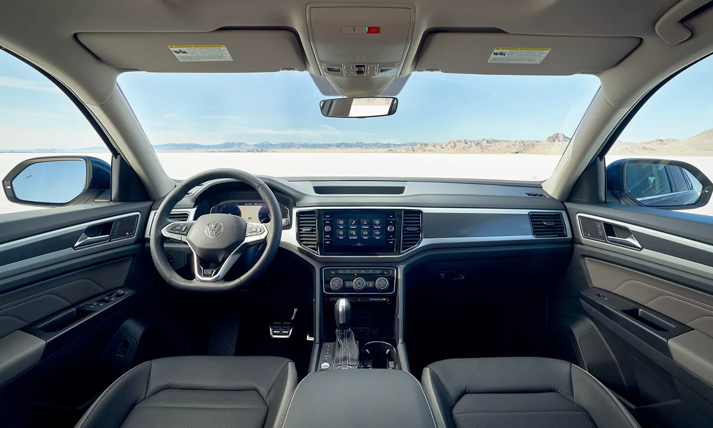 A view from behind the driver’s seat showing the interior dashboard and steering wheel of an Atlas.