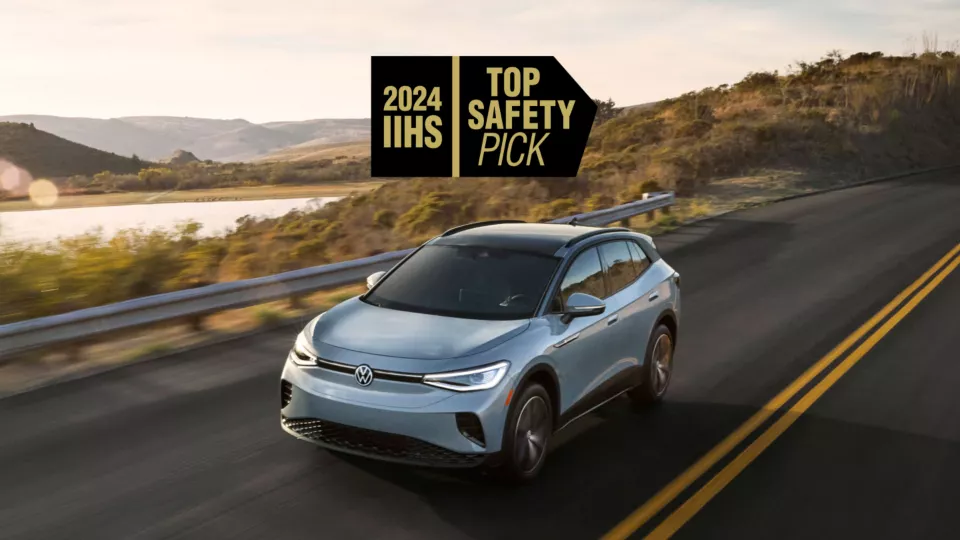 Stylized black and gold logo from the Insurance Institute for Highway Safety (IIHS) that reads “2024 IIHS” and “Top Safety Pick” above a 2024 ID.4 driving down the road