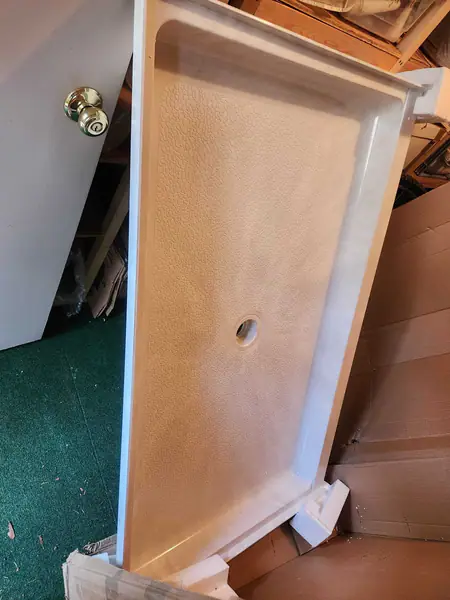 Solid surface shower base
