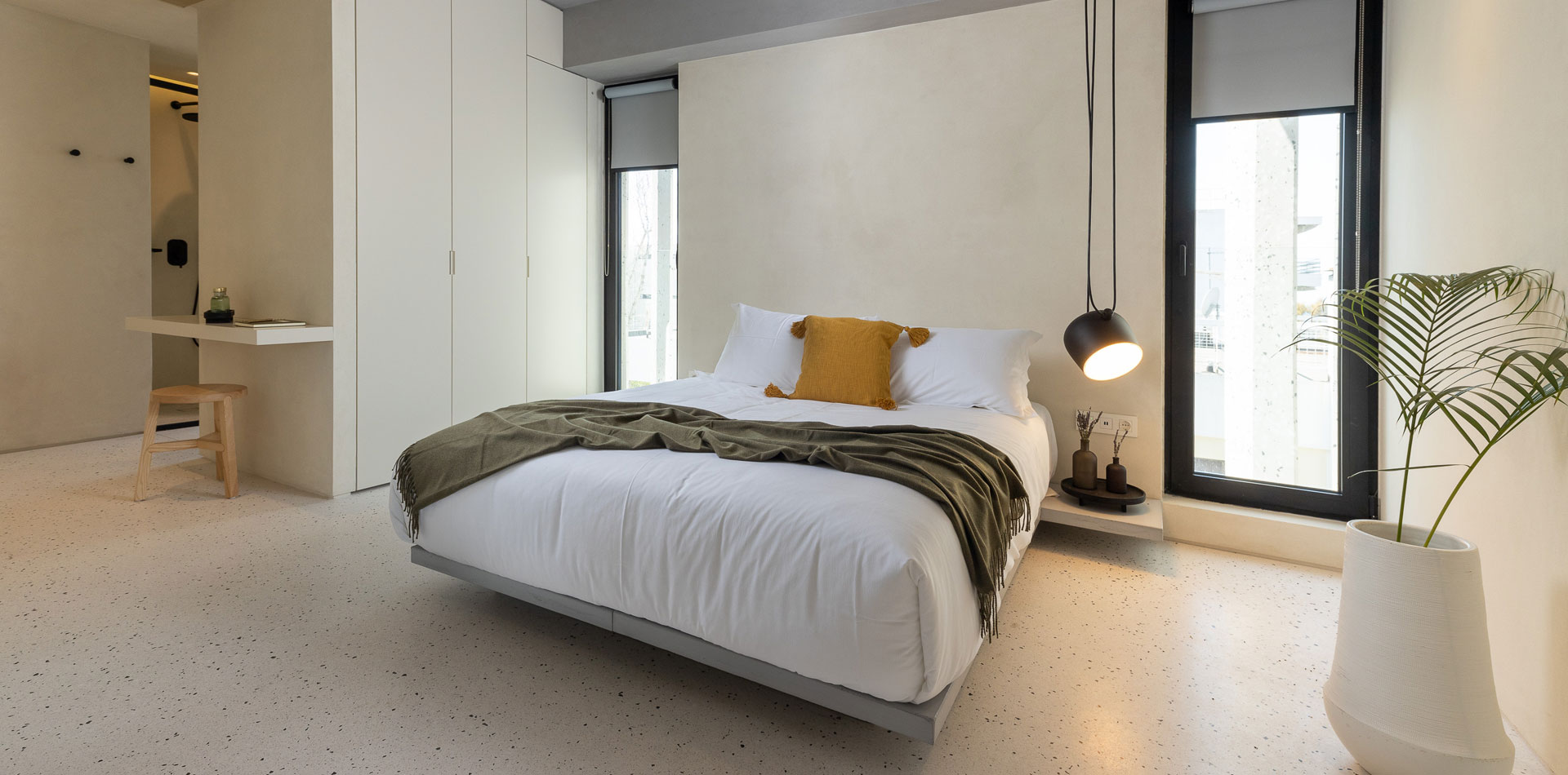 Bedroom with double bed and minimal aesthetic