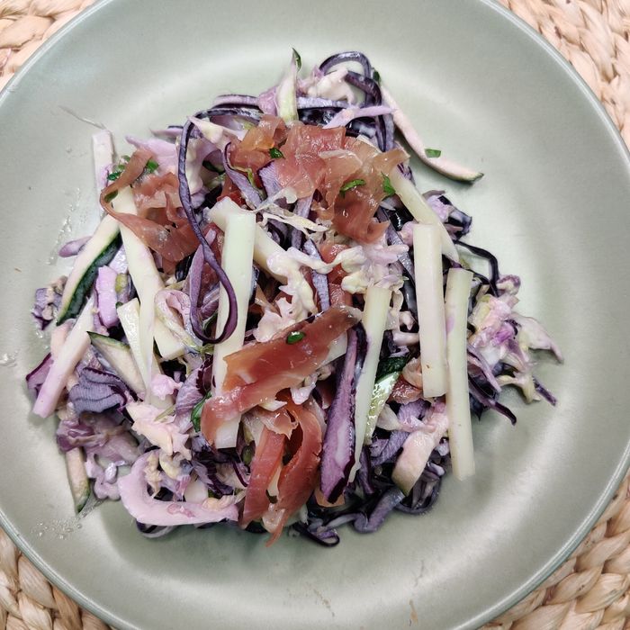 Red cabbage salad with zucchini, cheese, mayonnaise, and ham shavings