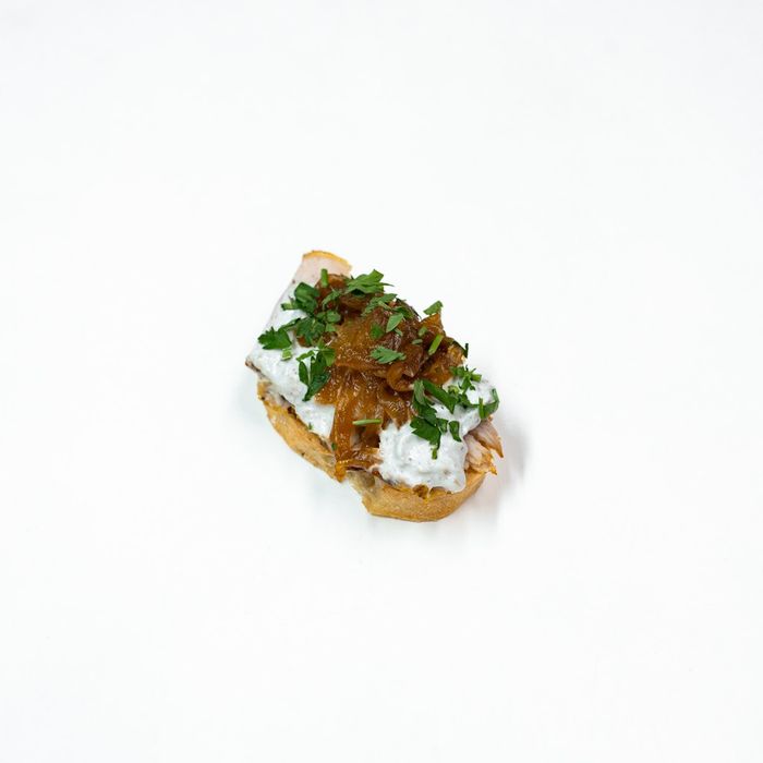 Sweet treat canapé with caramelized onion and cheese sauce